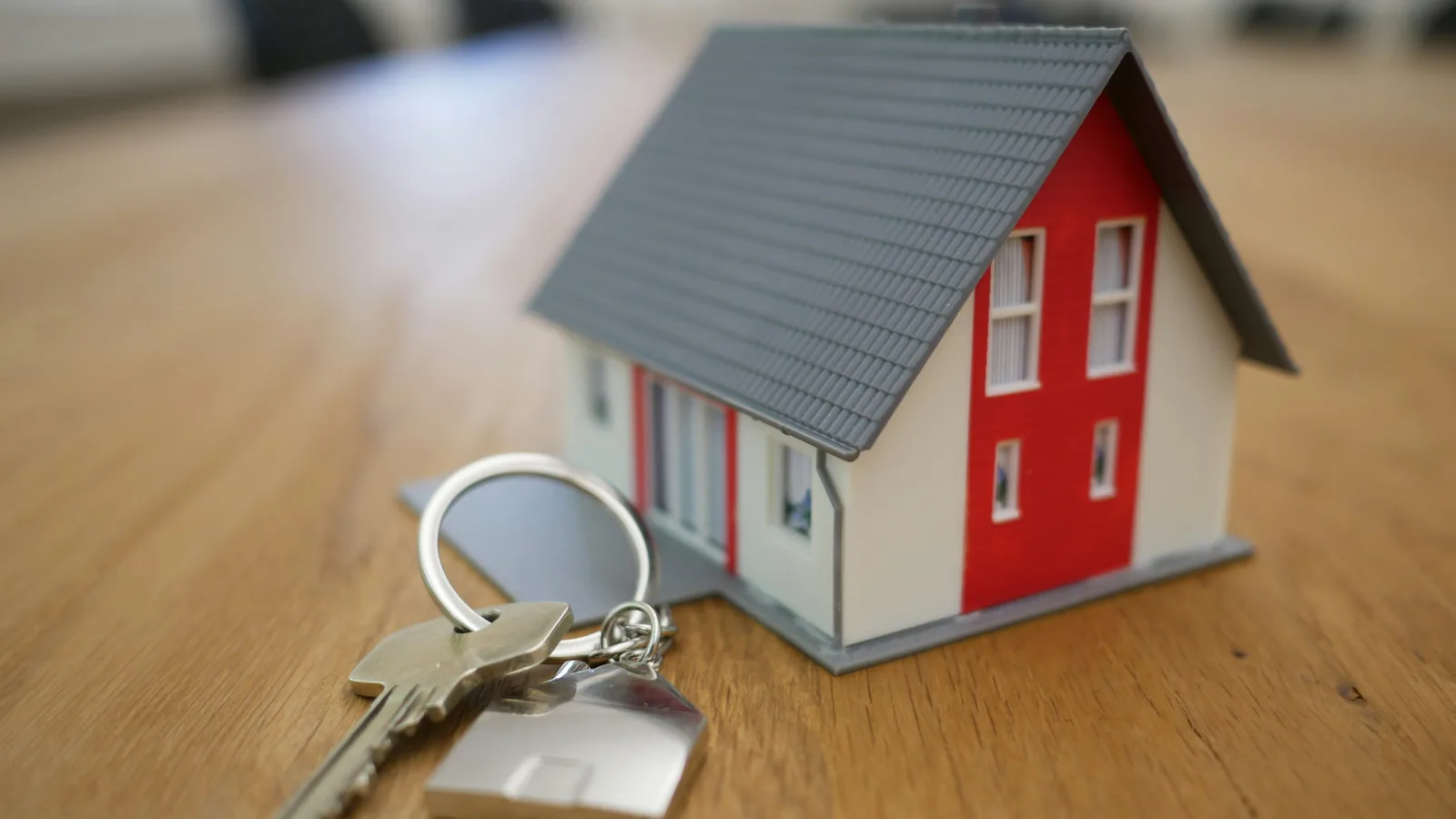 Maquette de maison avec clés, symbolisant la revente d’un bien soumise à la taxe sur le profit immobilier (TPI).